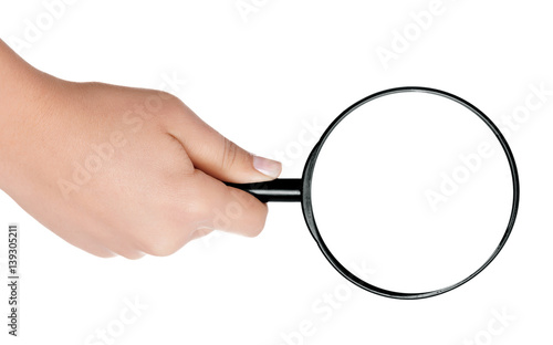 Female hand holding the magnifying glass isolated on white background