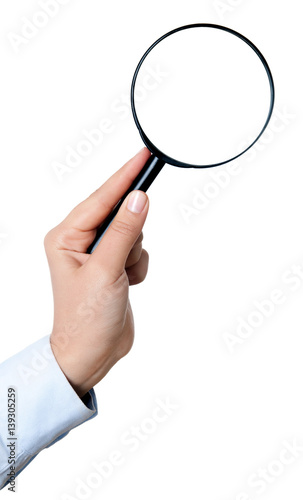 Female hand holding the magnifying glass isolated on white background