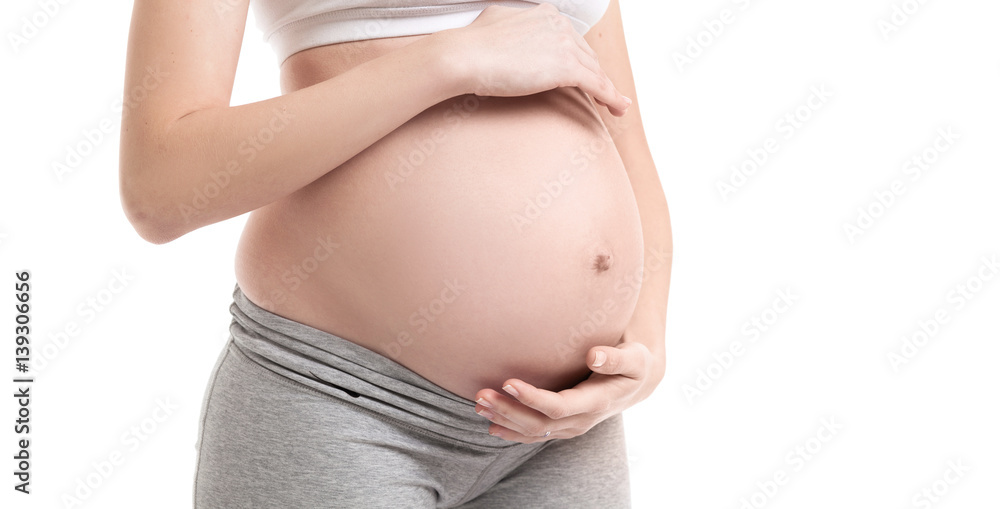 Close-up horizontal studio shoot of pregnant woman touching her belly. Pregnant woman isolated on white studio background Close-up horizontal studio shoot of pregnant woman touching her belly. Pregnant woman isolated on white studio background