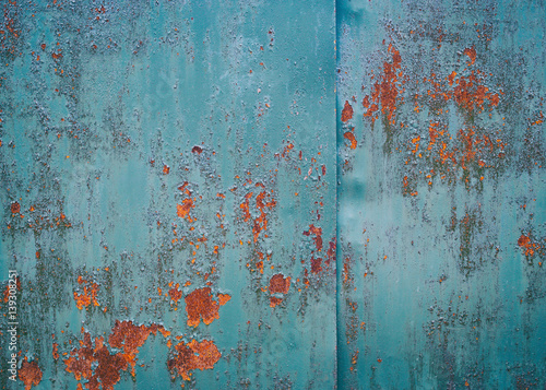 Vintage background. Old iron sheet painted in blue paint. The paint peeled off. in the ability to make some places rusty sheet. Traces of rust in several places