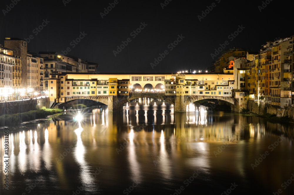 Night bridge Ponte Vecchio over Arno river in Florence