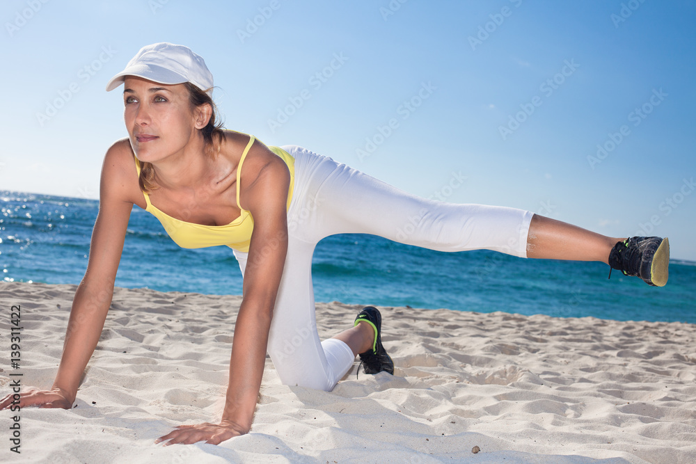 femme faisant de la gymnastique sur une belle plage sur le sable femme faisant de la gymnastique sur une belle plage sur le sable