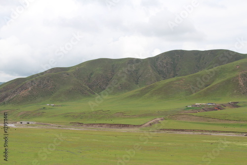 Amdo Tibet Tibetan Grassland Mountains Summer Grasslands Green Mountain Cloudy Sky China Qinghai