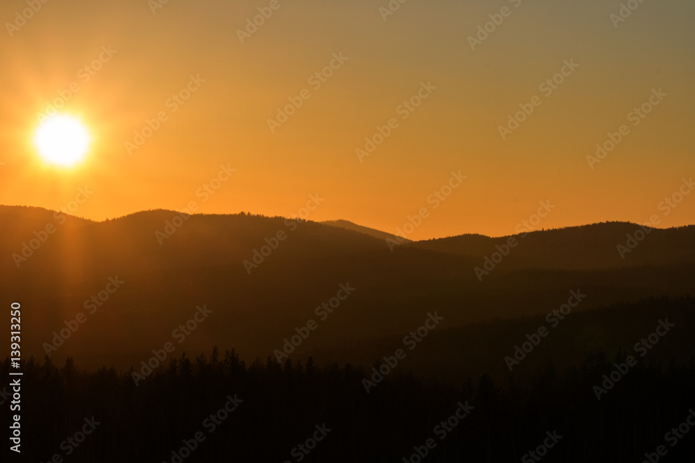 Sunset in the mountains. mountain landscape. Bright sunset over the tranquil mountains Sunset in the mountains. mountain landscape. Bright sunset over the tranquil mountains