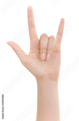 Hand shows the rock and roll sign or I love you sign isolated on a white background.