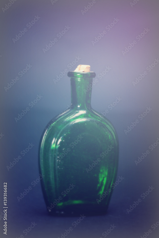 Old colourful bottles against a dark background Old colourful bottles against a dark background