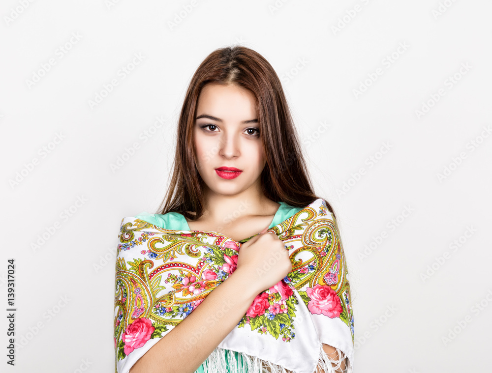 beautiful young woman dressed in a red dress and colored scarf posing in studio beautiful young woman dressed in a red dress and colored scarf posing in studio