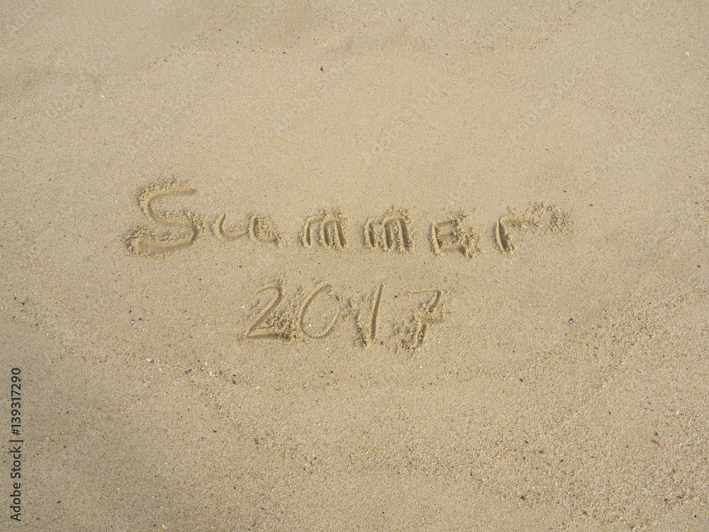 Fototapeta premium Summer 2017 written on sand