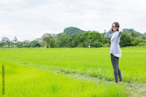 Woman standing in the rice fields. © vachiraphan