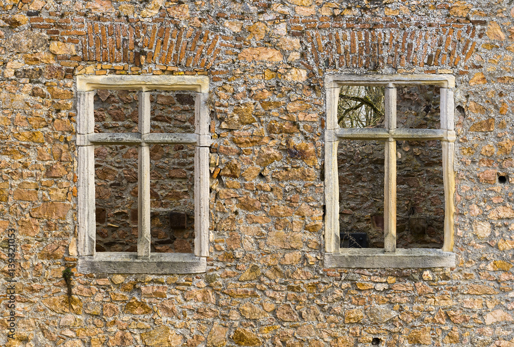 Two old window frames on a stone wall Two old window frames on a stone wall