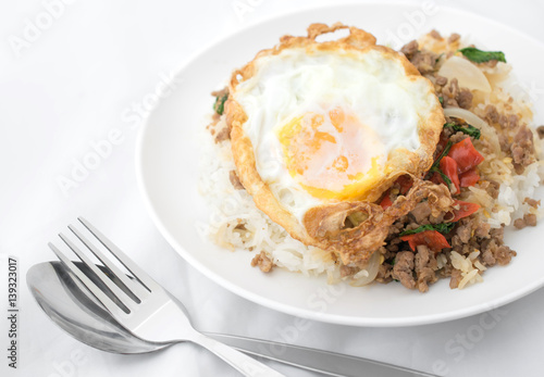 Fried basil leave with meat, Fried egg on rice spicy thai food.