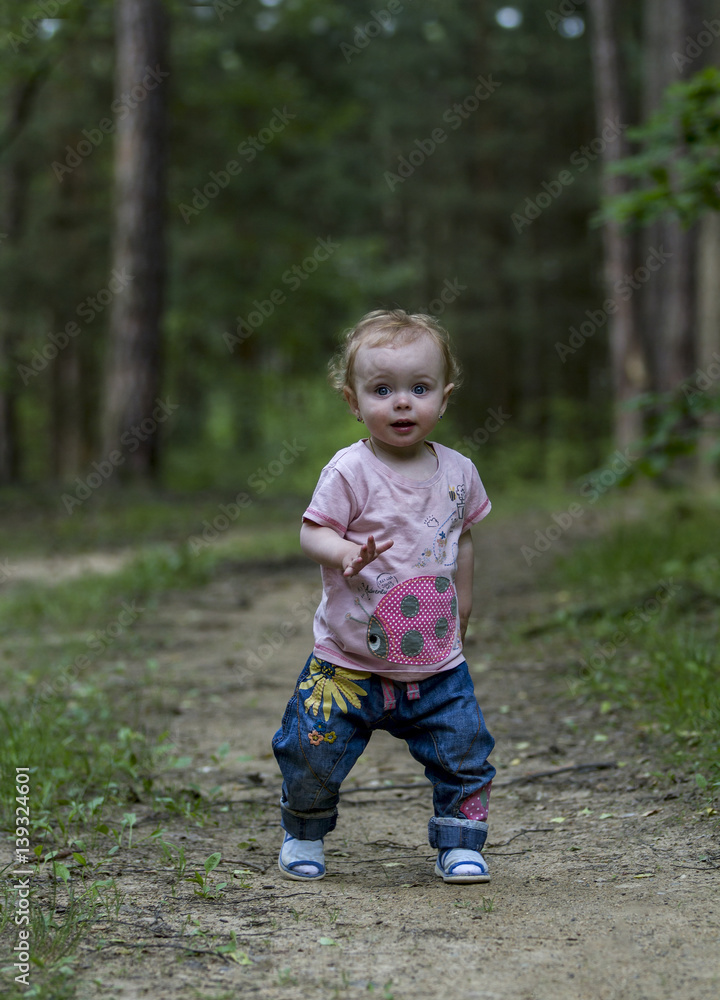 Little cute baby make his first steps on the forest road. Little cute baby make his first steps on the forest road.