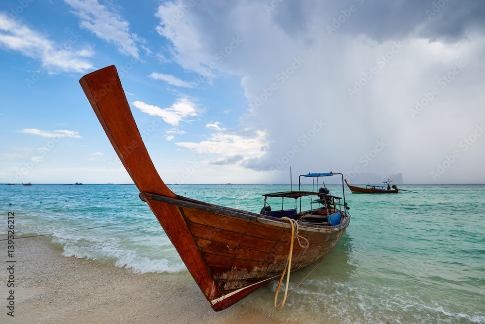 Koh Phi Phi, Thailand - 10 NOV: long tail boat at Koh Phi Phi on NOV 10, 2016. Traditional Thai boats carrying tourists on the nearby islands Koh Phi Phi, Thailand - 10 NOV: long tail boat at Koh Phi Phi on NOV 10, 2016. Traditional Thai boats carrying tourists on the nearby islands