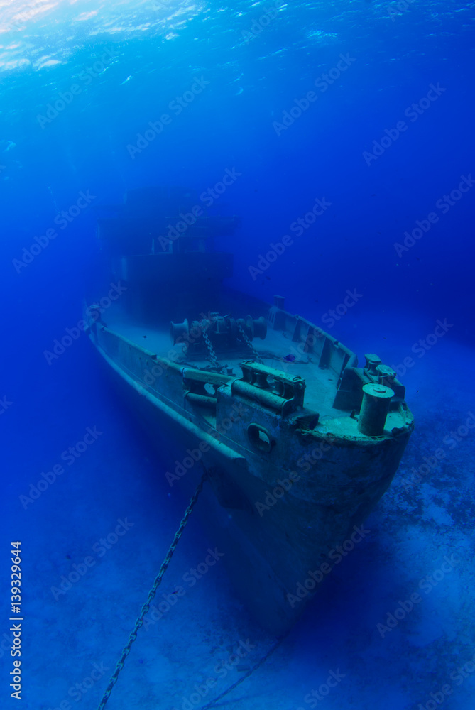 The bow of the USS Kittiwake shipwreck which sits in the warm shallow waters of Grand Cayman. The old submarine support vessel is now an underwater attraction for divers and snorkelers The bow of the USS Kittiwake shipwreck which sits in the warm shallow waters of Grand Cayman. The old submarine support vessel is now an underwater attraction for divers and snorkelers