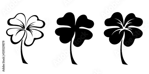 Carta da parati Set of three vector black silhouettes of four leaf clovers.