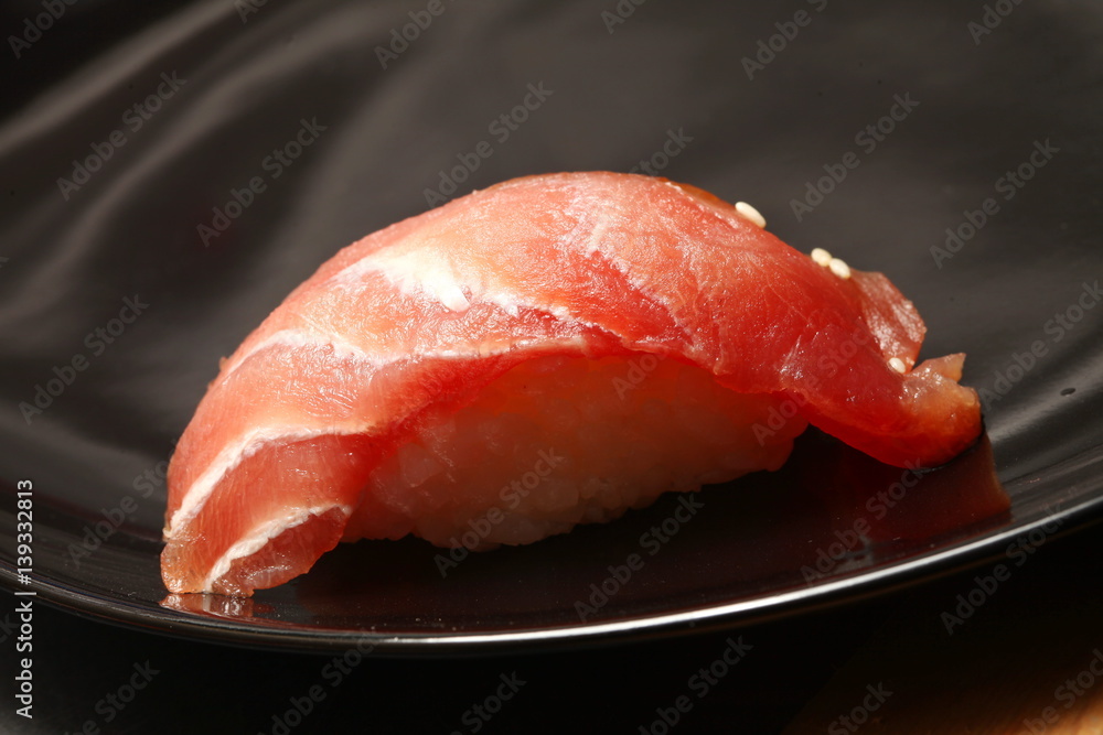 The japanese sushi on black color plate super macro shot represent the japanese food concept related idea. The japanese sushi on black color plate super macro shot represent the japanese food concept related idea.