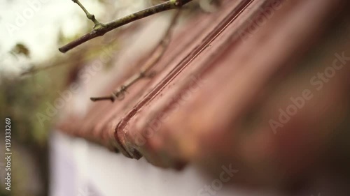 Ceramic tile roof with chimney and white wall, focus displacement