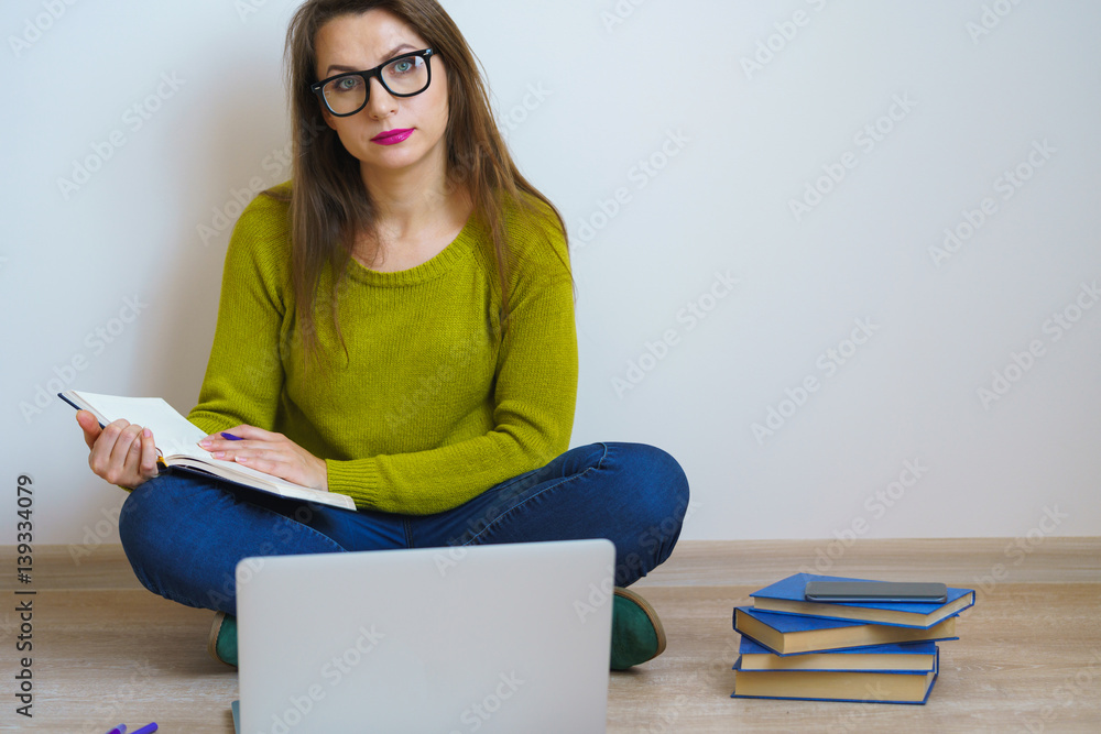 Beautiful girl using laptop sitting on the floor at home Beautiful girl using laptop sitting on the floor at home