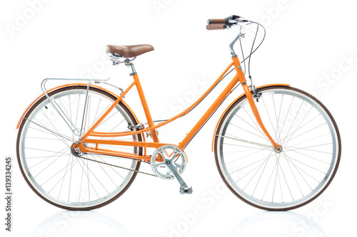 Stylish female orange bicycle isolated on white