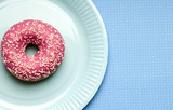 a paper party plate with a doughnut donut and copy space 