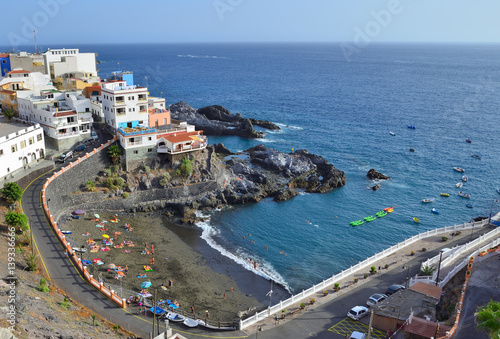Landscape of Tenerife with a small beach of black volcanic sand. Puerto de Santiago, Canary archipelago, Spain.