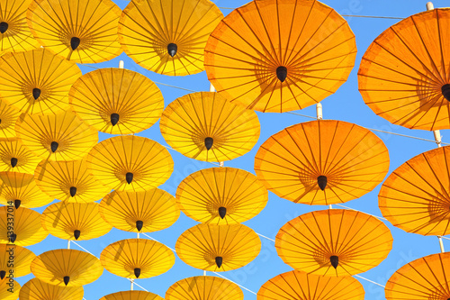 yellow paper umbrella  floating in the blue sky texture