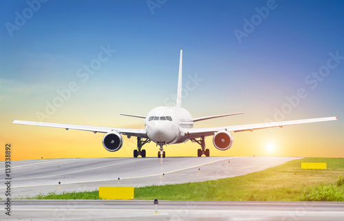 Large aircraft on taxiing sunset at the airport, the sky is the sun and the steering track