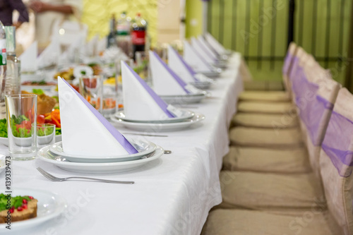 catering table set service with silverware, napkin and glass at restaurant before party