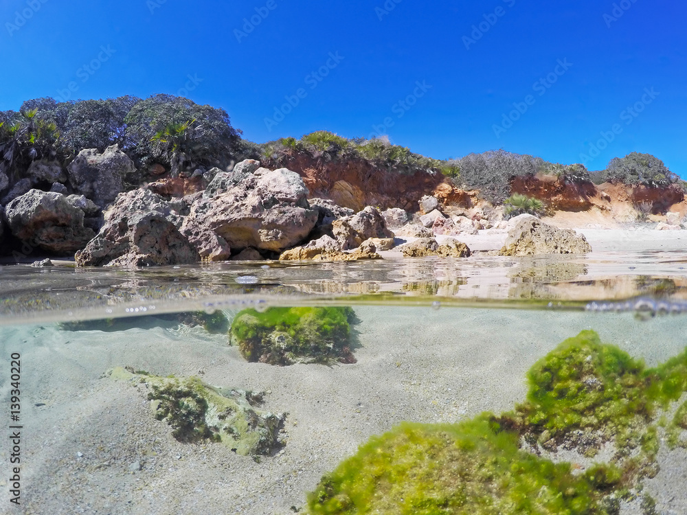 Split underwater view of Alghero shore