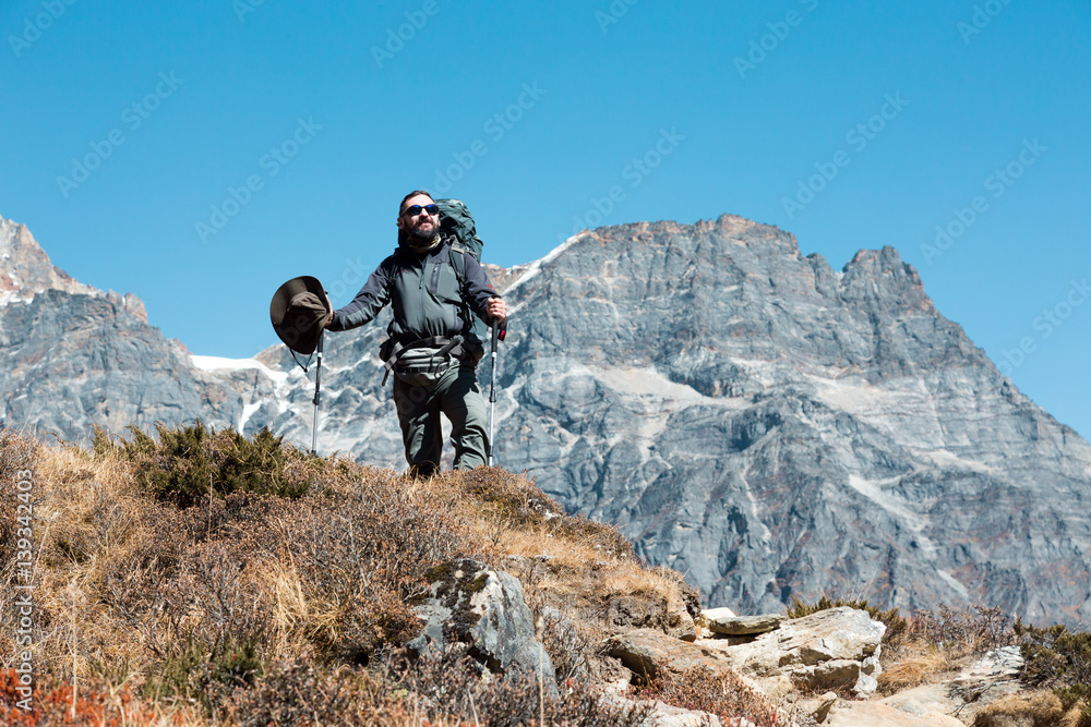 Mature bearded Hiker staying on Mountain Ridge