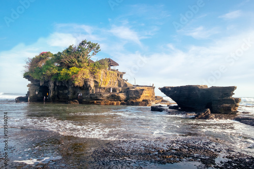Scenic sea view near famous tourist landmark of Bali island - Tanah Lot - traditional Buddhist water temple attraction. Tropical nature landscape of Indonesia, Asia