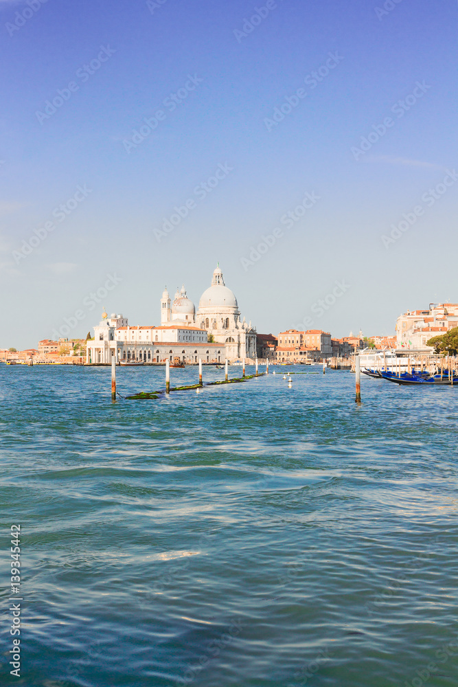 Basilica Santa Maria della Salute and Grand canal water, sunny day in Venice, Italy