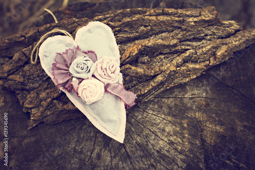 Hand-made heart on a wooden background.