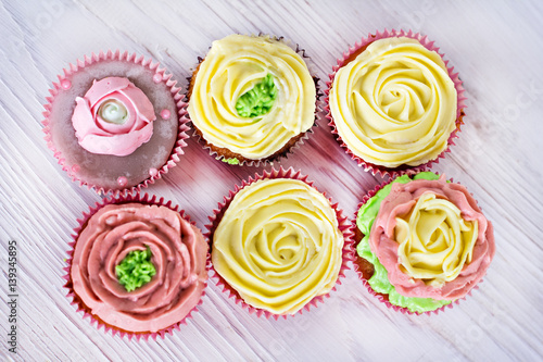 Tasty cupcakes on bright background