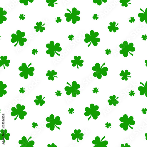 Vector St. Patrick s day seamless pattern with green shamrock leaves on a white background.