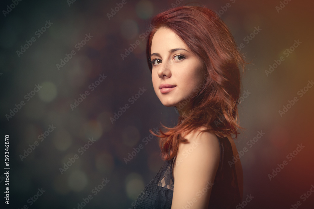 beautiful young woman standing in front of wonderful black studio background