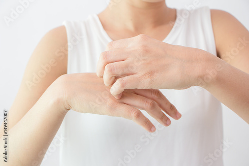 Women scratch the itch with hand / arm itching / Concept with Healthcare And Medicine.