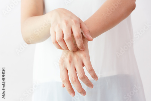 Tableau sur toile Women scratch the itch with hand / arm  itching / Concept with Healthcare And Medicine