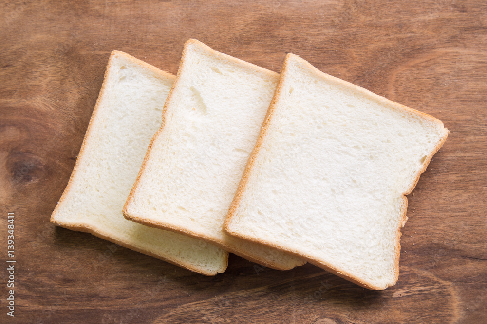 Sliced bread on wooden background.