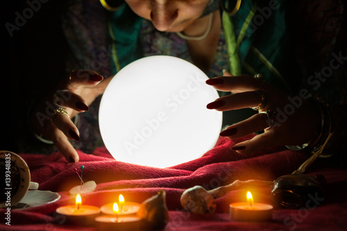 Fortune teller woman looking at crystal ball