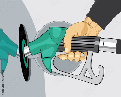 Hand refilling car with fuel nozzle on petrol station