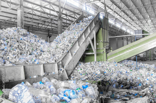 closeup escalator with a pile of plastic bottles at the factory for processing and recycling. PET recycling plant photo