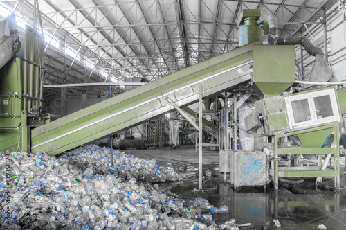 Fotografie escalator with a pile of plastic bottles at the factory for processing and recycling