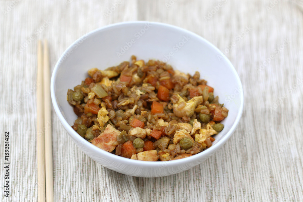 Fried rice with chicken, vegetables (peas, carrot, onion, garlic), egg and soy sauce. Selective focus. Fried rice with chicken, vegetables (peas, carrot, onion, garlic), egg and soy sauce. Selective focus.