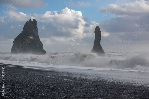 Rocks and waves at Vik black beach - breathtaking Iceland in winter - amazing landscapes, storms and blizzards - photographers paradise