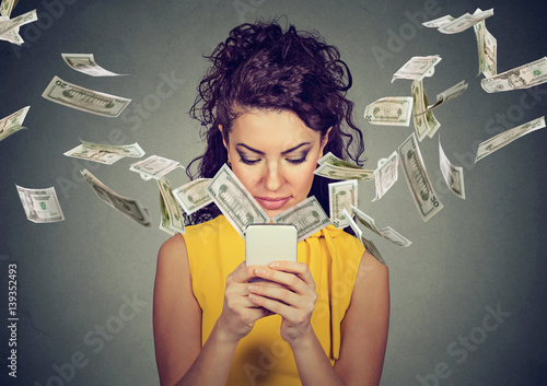 фотографія woman using smartphone making money