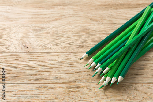 Drawing green pencils on a wooden background photo