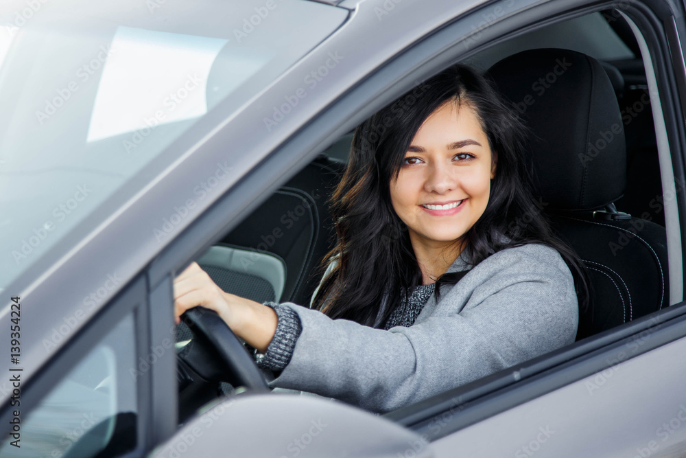 Portrait of a happy young woman in the new car Portrait of a happy young woman in the new car