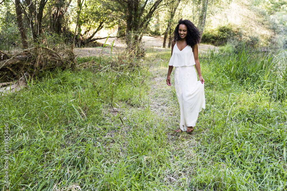 portrait outdoors of a young afro american woman. Green background. Lifestyle portrait outdoors of a young afro american woman. Green background. Lifestyle