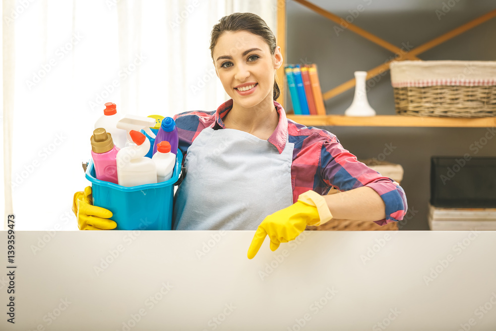 Cheerful Young Housewife Holding Bucket With Cleaning Supplies